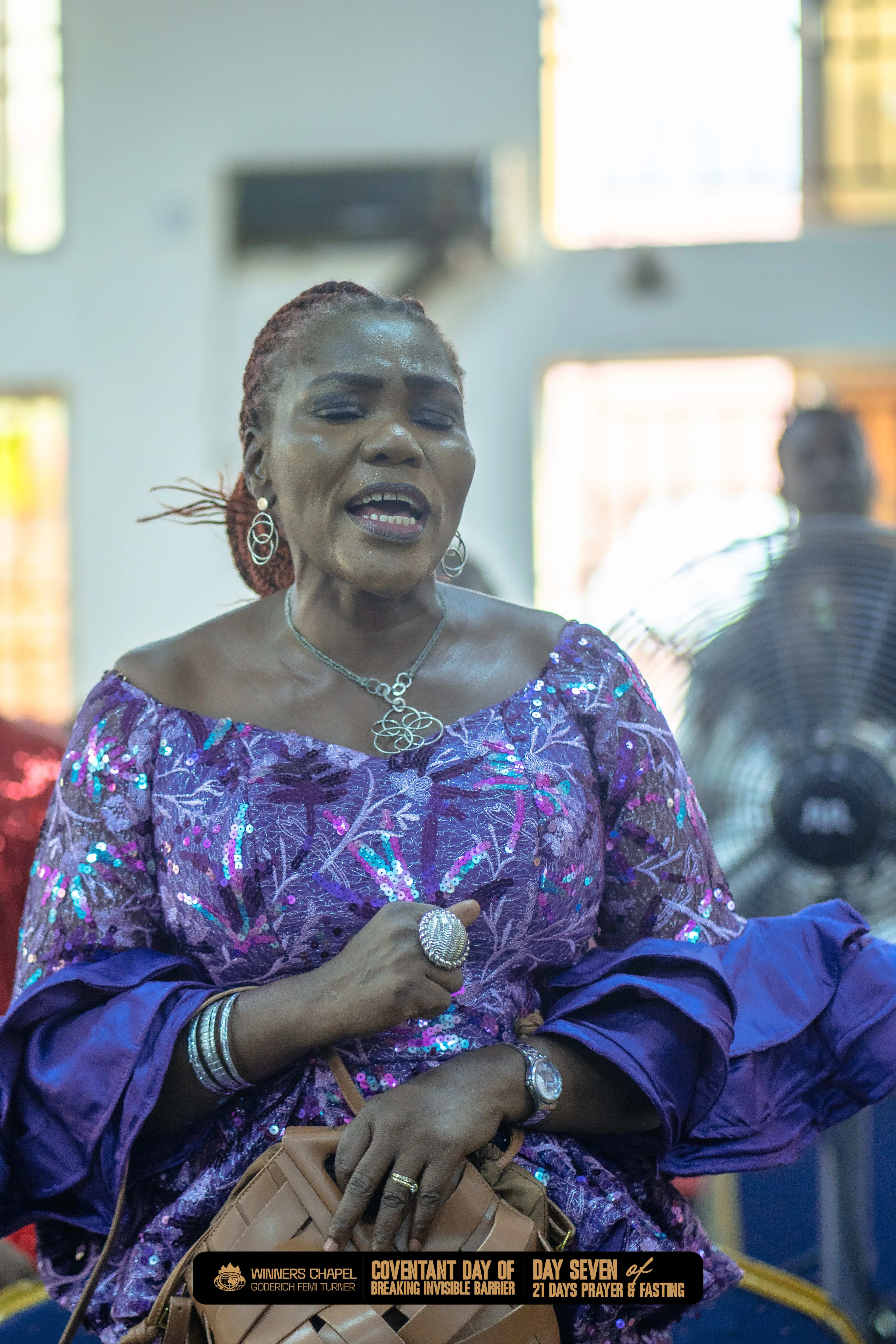 Woman praying during service